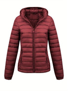 Lumina Wear Isla lightweight quilted hooded puffer jacket with fleece lining in black, shown on a model.