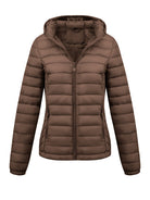 Black Isla lightweight quilted hooded puffer jacket with fleece lining by Lumina Wear, shown on a hanger.