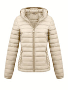 Black Isla Lumina Wear lightweight quilted hooded puffer jacket with fleece lining, shown on a mannequin in XS size.