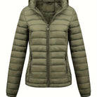 Black Isla Lumina Wear lightweight quilted hooded puffer jacket with fleece lining, shown on a model in size XS.