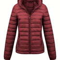 Black Isla Lumina Wear lightweight quilted hooded puffer jacket with fleece lining, shown on a model, front view.
