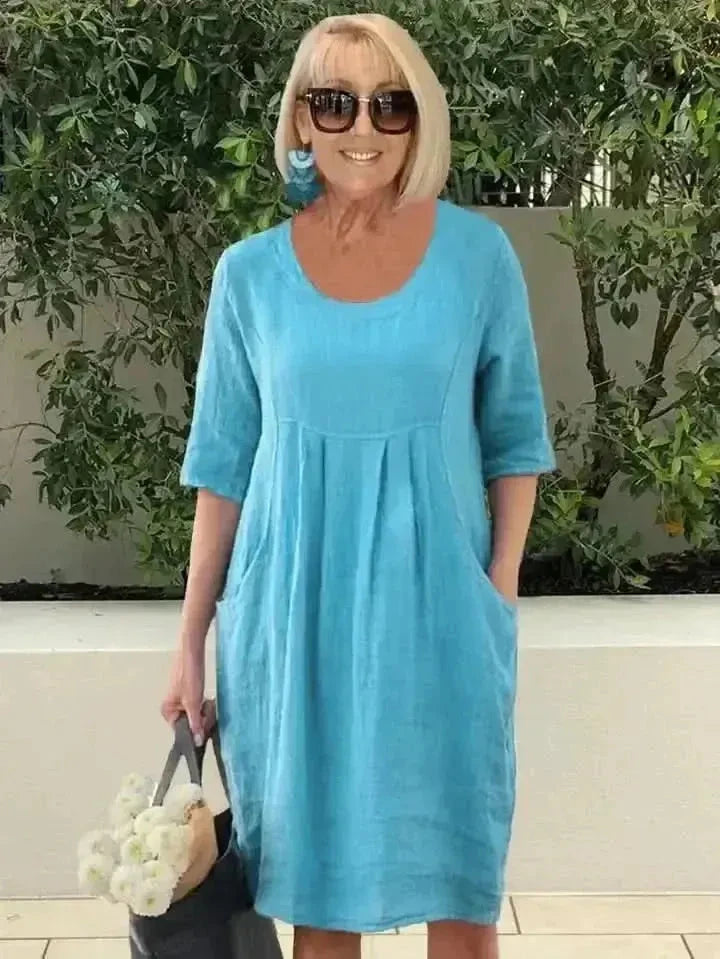 Blue loose dress with pockets by Lumina Wear, featuring a relaxed fit and casual style, shown on a model.