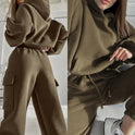 Black Jasmine Lumina Wear relaxed fit cargo pocket hoodie and sweatpants tracksuit set laid flat, showcasing comfortable casual style.