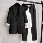Black women's 2-piece set with tailored blazer, sleek pants, and versatile top from Lumina Wear, styled for a chic look.