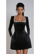 Black Garance Mini Dress from Lumina Vancouver's Isabeau Collection, perfect as a wedding guest dress, shown on a size 8-10 model.