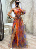Lumina Wear Kayla one-shoulder floral maxi dress in purple, flowing fabric with a stylish design and vibrant floral pattern.