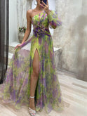 Lumina Wear KAYLA one-shoulder floral purple maxi dress displayed on a model, flowing fabric with a stylish design.