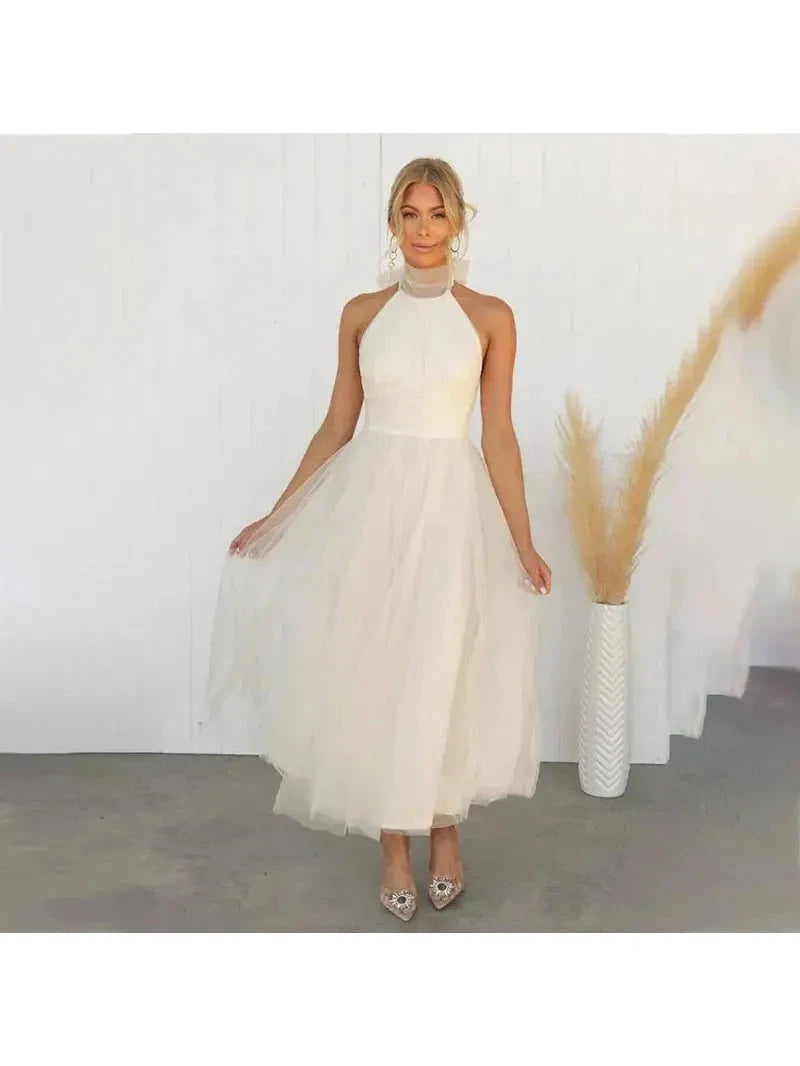 Cream-colored Kaylee Fairy Dress by Lumina Wear, elegant evening dress with delicate details, perfect for wedding guests and special occasions.