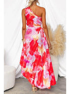 Red Kelsey pleated summer dress by Lumina Vancouver, perfect for wedding guests, shown on a model with flowing fabric.