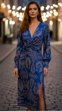 Blue Lara elegant dress by Lumina Wear, shown on a mannequin, featuring a fitted bodice and flowing skirt.
