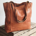 Elegant black leather handbag by Lumina Wear featuring a spacious interior and stylish design, perfect for daily use.