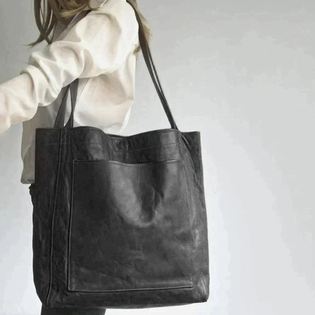 Elegant black leather handbag by Lumina Wear with spacious interior and stylish design, perfect for daily use.