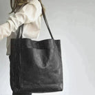 Elegant black leather handbag by Lumina Wear with spacious interior and stylish design, perfect for daily use.