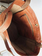 Elegant black leather handbag by Lumina Wear with spacious interior, featuring brown accents and dimensions 36x13x42cm.