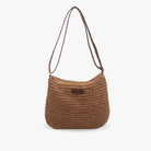 Chic beige straw shoulder bag by Lumina Wear featuring vegan leather accents and a stylish design.