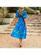 Blue Leona elegant midi dress by Lumina Vancouver, perfect for wedding guests, with a flowing silhouette and stylish design.