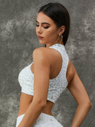 Leopard print Lumina Vancouver sports bra with zipper, stand collar, white color, paired with leggings for active wear.