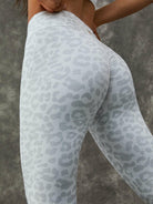 Leopard print Lumina Vancouver sports bra with zipper, stand collar, and white color, paired with matching leggings.