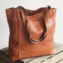 Chestnut brown Lumina Lila elegant versatile city handbag with smart storage, featuring sleek design and multiple compartments.