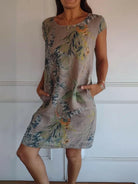 Lillian™ casual printed dress by Lumina Vancouver, featuring a white fabric with colorful floral patterns, lightweight and stylish.