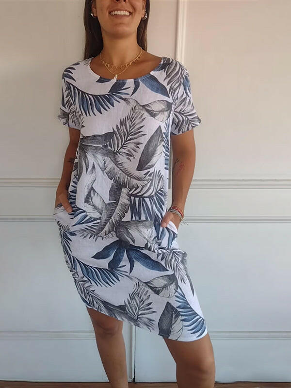 Lillian™ casual printed dress by Lumina Vancouver, white fabric with floral pattern, displayed on a hanger.