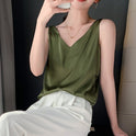 Black Lily satin tank top with relaxed fit and V-neck by Lumina Wear, shown on a model.