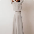 Black Lily two-piece set by Lumina Wear with a contemporary cropped top and wide-leg trousers, styled for modern elegance.