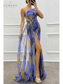 Blue Lumina Wear Blanche off-shoulder slit printed maxi dress worn by a wedding guest, featuring a flowing design and elegant style.