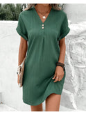 Green V-neck spring dress by Lumina Wear, featuring a stylish and comfortable design, shown on a model.