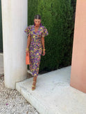 Purple Lumina Wear Loren midi dress with vibrant puff sleeves, stylish and flowy for elegant occasions.
