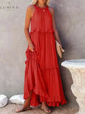 Apricot Lorena halterneck dress with ruffles and pockets by Lumina Wear, perfect for holiday vibes, shown on a model.