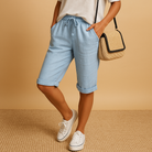 Relaxed light blue Capri trousers with drawstring from Lumina Wear, casual fit, lightweight fabric, suitable for warm weather.