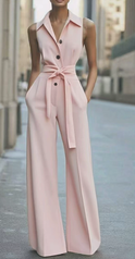 Orange sleeveless jumpsuit by Lumina Wear, featuring a fitted bodice and wide-leg pants, displayed on a hanger.