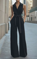 Orange sleeveless jumpsuit by Lumina Wear featuring a fitted style and wide-leg pants, displayed on a hanger.