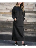 Black Elisa hooded dress by Lumina Wear, featuring a comfortable fit and stylish design, shown on a model in the image.