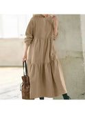 Black Lumina Wear Isabella long-sleeved hoodie dress with a relaxed fit, shown on a model in a casual indoor setting.