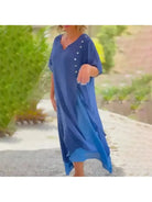 Blue Lumina Vancouver Rosalie classic solid color maxi dress displayed on a hanger with flowing fabric and simple design.