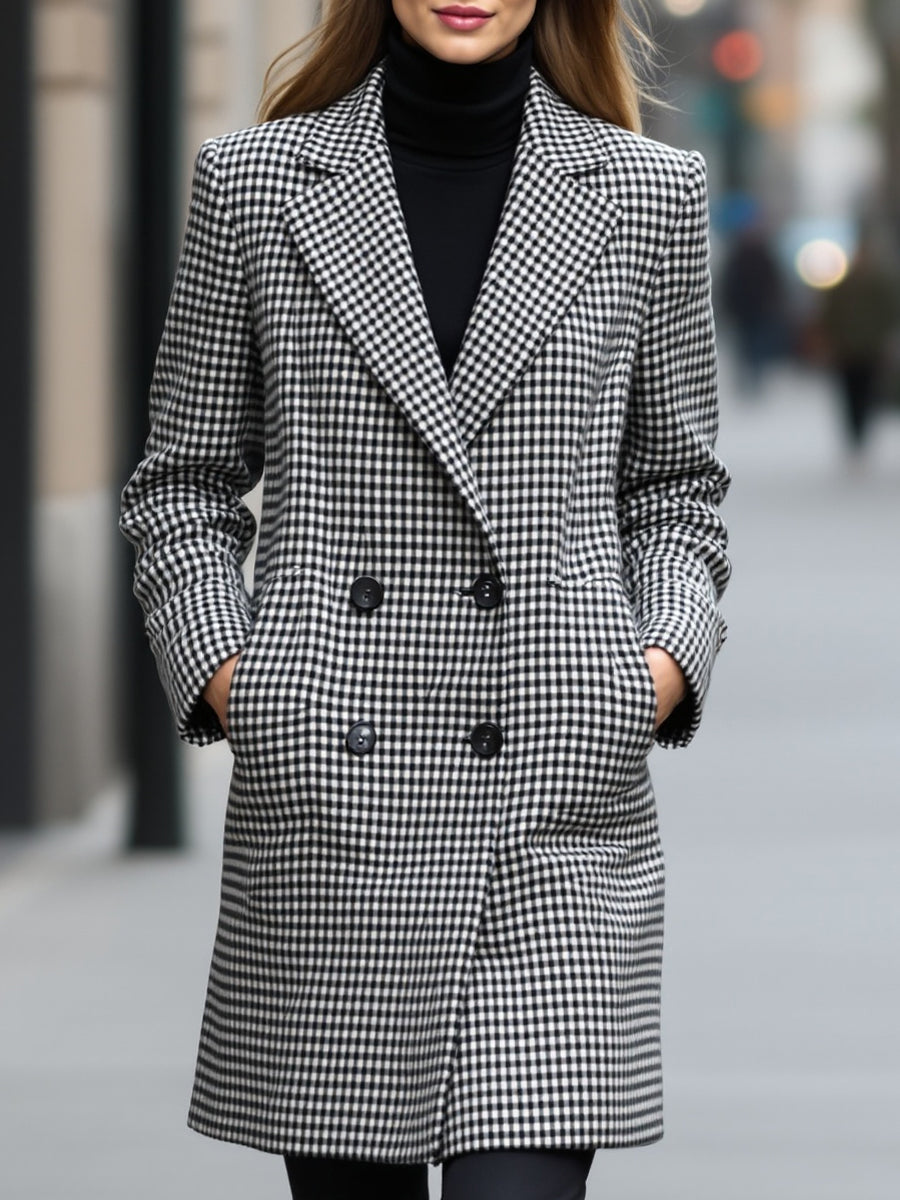 Black Enid Lumina Vancouver double-breasted checked wool coat displayed on a hanger, showcasing classic pattern and tailored fit.