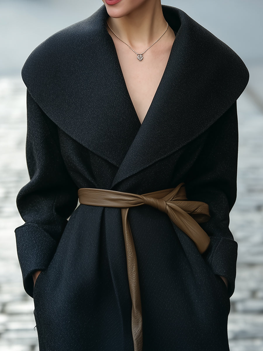 Black Lumina Vancouver Tabitha shawl-collar wrap coat with faux leather belt, shown on a model, close-up of coat details.