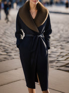 Black Lumina Vancouver wool coat with oversized fur collar, styled on a model, showcasing its elegant and cozy design.
