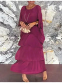 Dark green Lumina Wear Caroline loose round neck dress displayed on a hanger, showcasing its relaxed fit and simple style.