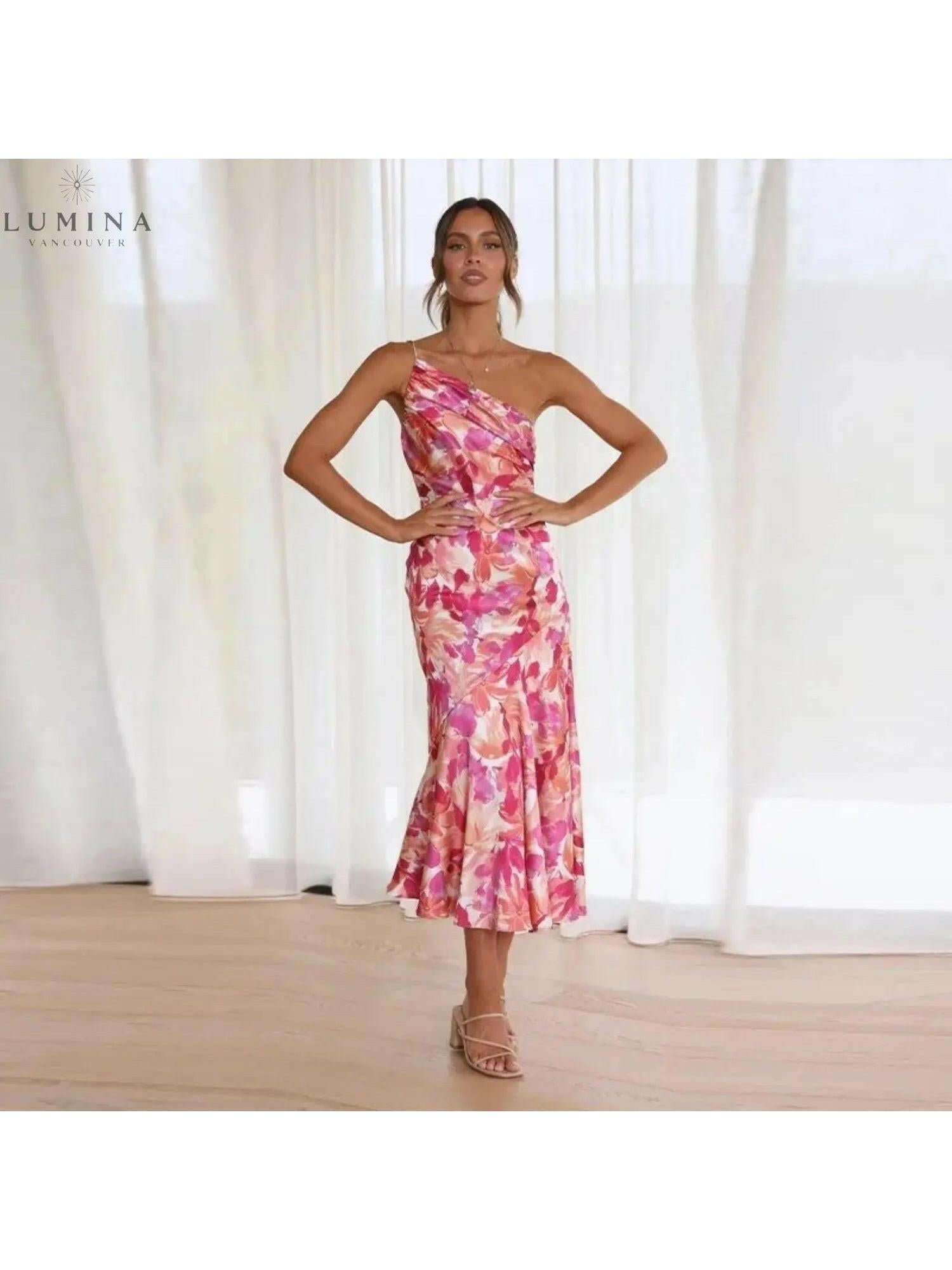 Orange floral patterned dress by Lumina Vancouver featuring a stylish, flowy design perfect for casual or semi-formal wear.