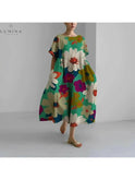 Lumina Wear Amelia floral dress with a vibrant flower pattern, featuring a flowy silhouette and elegant design.