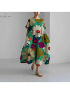 Lumina Vancouver Amelia floral dress displayed on a hanger with colorful flower patterns and lightweight fabric.