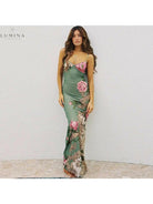 Lumina Vancouver Gaia Flower Dress with holiday vibes in green, featuring floral patterns and lightweight fabric for festive occasions.