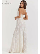 Lumina Vancouver Mireille Romantic Summer Dress in white, perfect for holiday vibes, displayed on a model with flowing fabric.