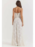White Mireille Romantic Summer Dress by Lumina Vancouver, perfect for holiday vibes, shown on a woman in a beach setting.