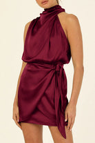 Apricot satin halter mini dress by Lumina Vancouver featuring a sleek fit and elegant design, perfect for stylish occasions.