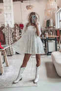 Apricot loose-fit tiered mini dress by Lumina Wear, styled on a model showcasing its flowing, layered design and casual elegance.