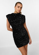 Black sequin embellished mini dress by Lumina Vancouver, featuring a fitted silhouette and stylish design.